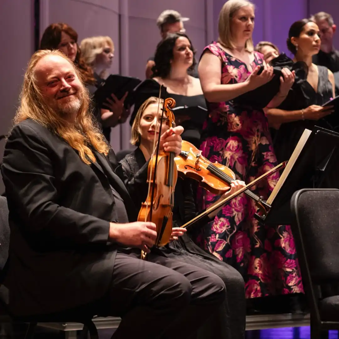 Carmel Bach Festival Carmel Bach Festival. A violinist photo from the festival. Smiling and giving a look to the camera.